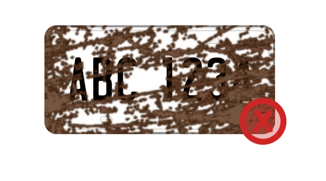 Licence plate covered in mud, dirt, or snow